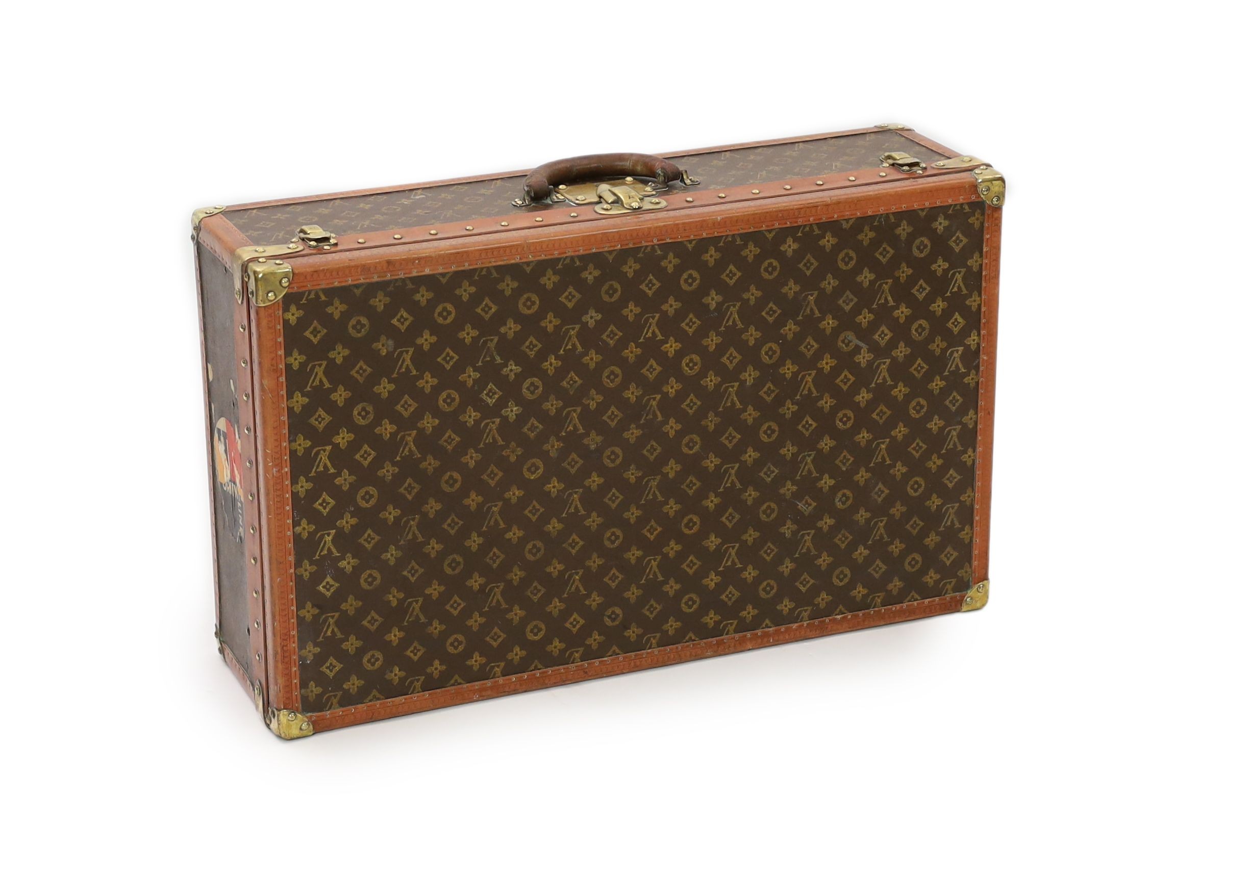 A Louis Vuitton brass mounted leather bound suitcase, 76 x 46cm depth 22cm